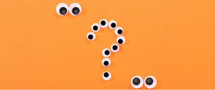 orange image with a white question mark on it made out of googly eyes for digital body language